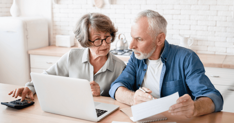 Senior couple at the table reviewing funding for senior living