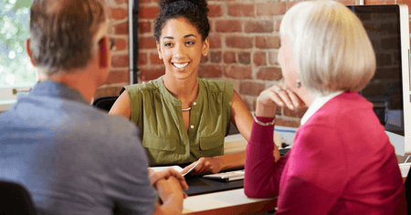 Senior couple speaking with female adult on paying for memory care