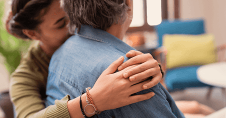 Memory care resident being hugged by daughter