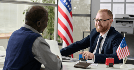 Men at desk discussing VA benefit for senior living