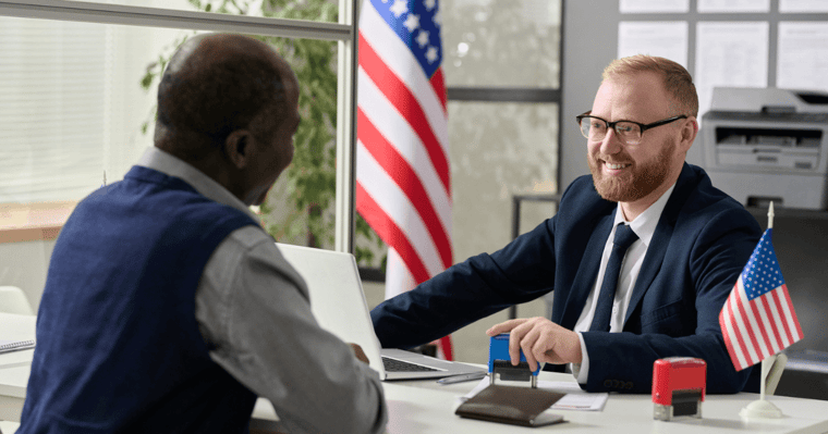 Men at desk discussing VA benefit for senior living