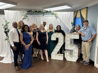 tallahassee team stands with a lighted 25 sign