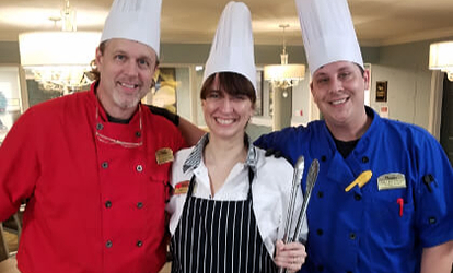 Chefs in the kitchen smiling.