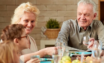 Family talking at a dining table. 