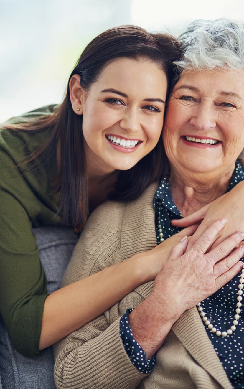 Adult child hugging parent.