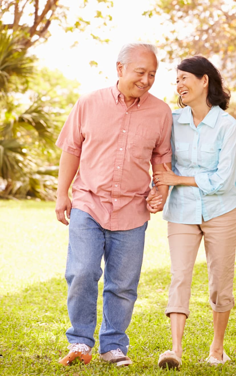 Couple walking through a park.