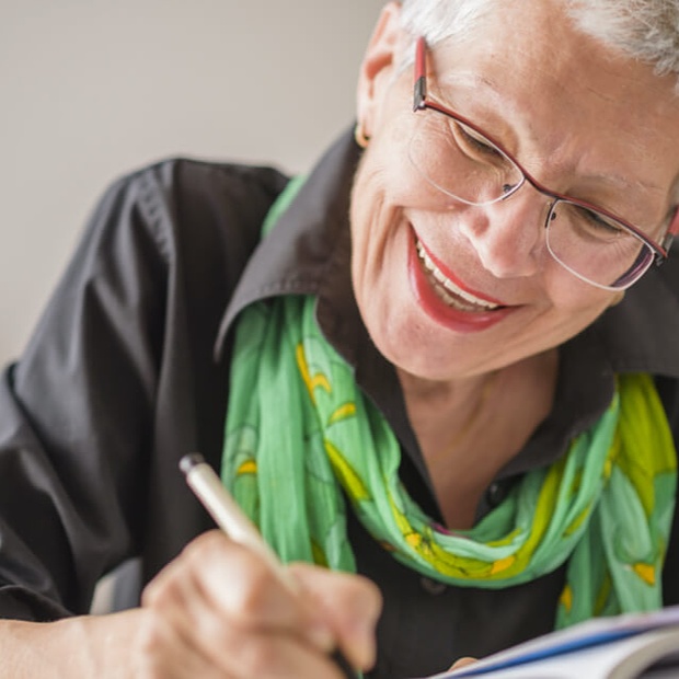 Woman writing in a journal. 