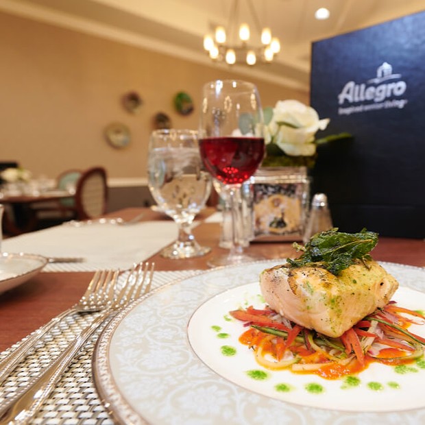 Plate of salmon set at the Allegro dining tables.