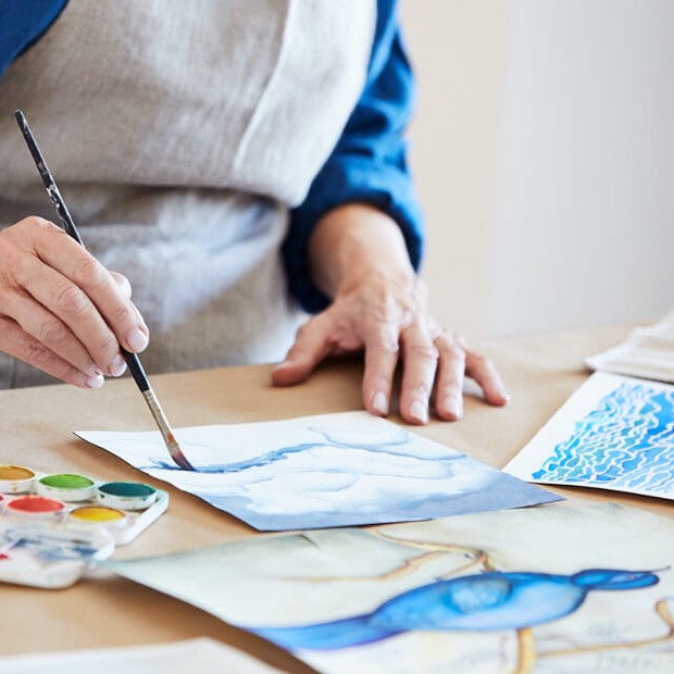 Woman painting a picture.