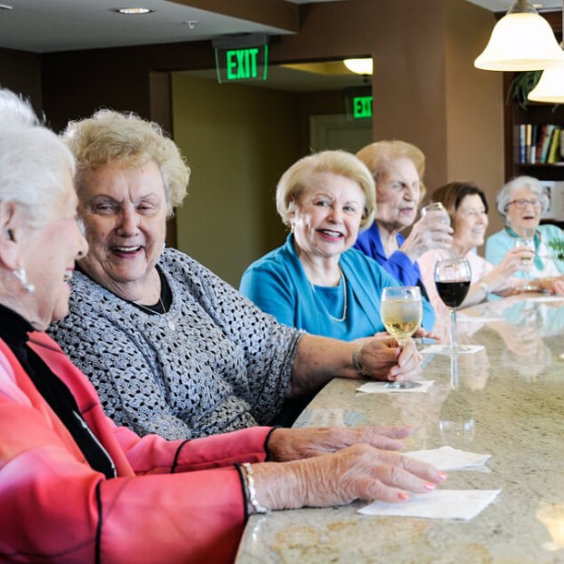 Group of women enjoying drinks at happy hour.