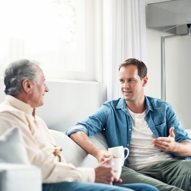 Son talking to his father. 