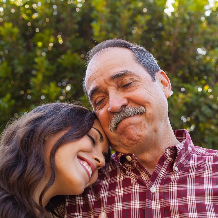 Father and daughter leaning on one another. 