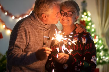 couple kissing in front of christmas tree 