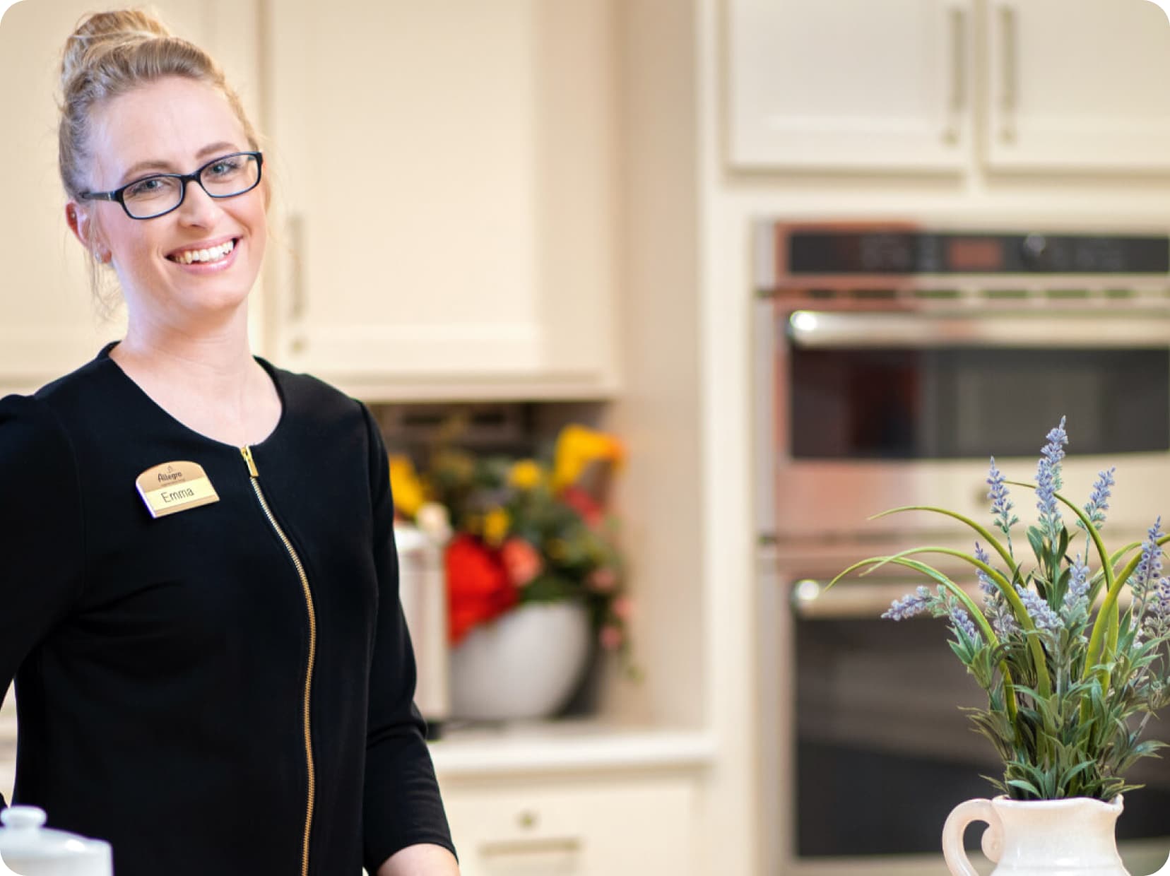 Allegro worker Emma smiling in the kitchen.
